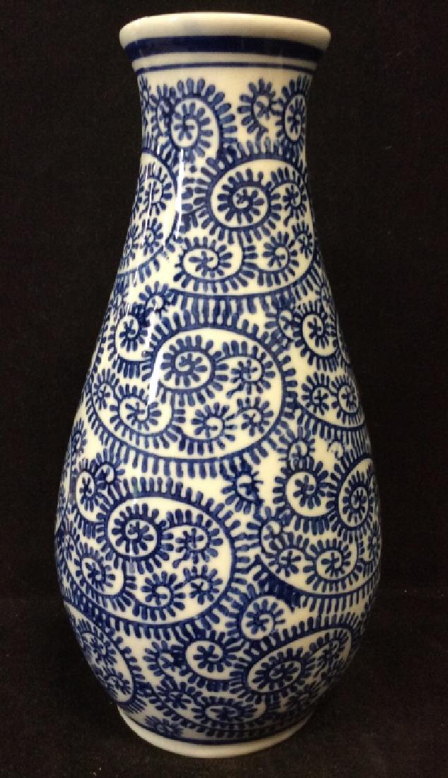 Blue and White Porcelain Vase: Blue and white organic swirl design, measures approx 10 in by 5 in in diameter at widest. vase vessel, tableware, tabletop accessory, decorative arts and accessories, 4