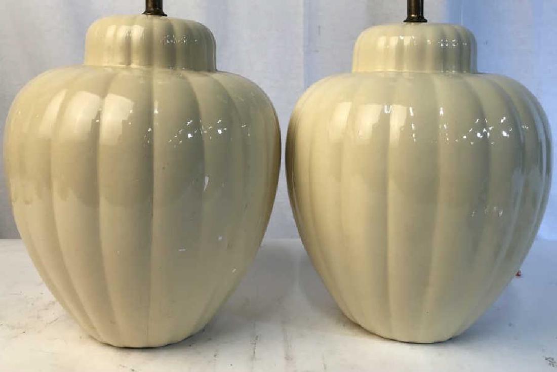 Pair MCM Vanilla Toned Ceramic Lamps: Porcelain ceramic lamps in ribbed ginger jar forms, mid century modern lamps, property of Greenwich Conn Estate, each measures ht 23 inches to harp top