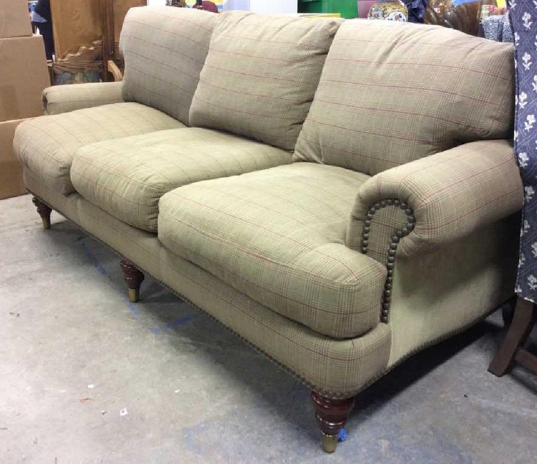 LILLIAN AUGUST Sofa W Nail Head Detail: Sofa has tones of olive, orange, and red. Piece also has nail head detail. Label underneath cushion reads LILLIAN AUGUST. MEASURES approx 86 inches long 42 inches deep, 34 inches tall. Home furnishing