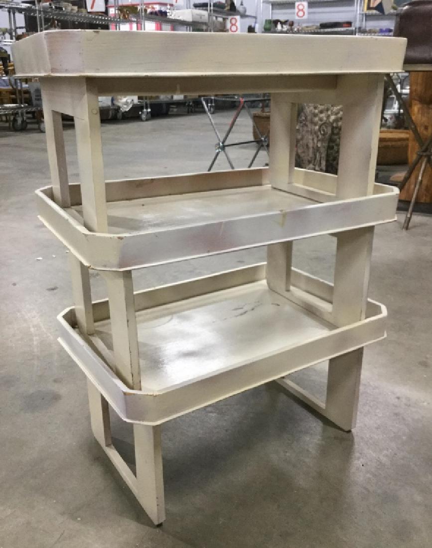 Set painted three stack able tables: Trays, tables end tables set of three painted white, together ht app 25 inches surface app 19 by 13 inches, separately are tray tables, together as end table, side table, occasional table plant stand