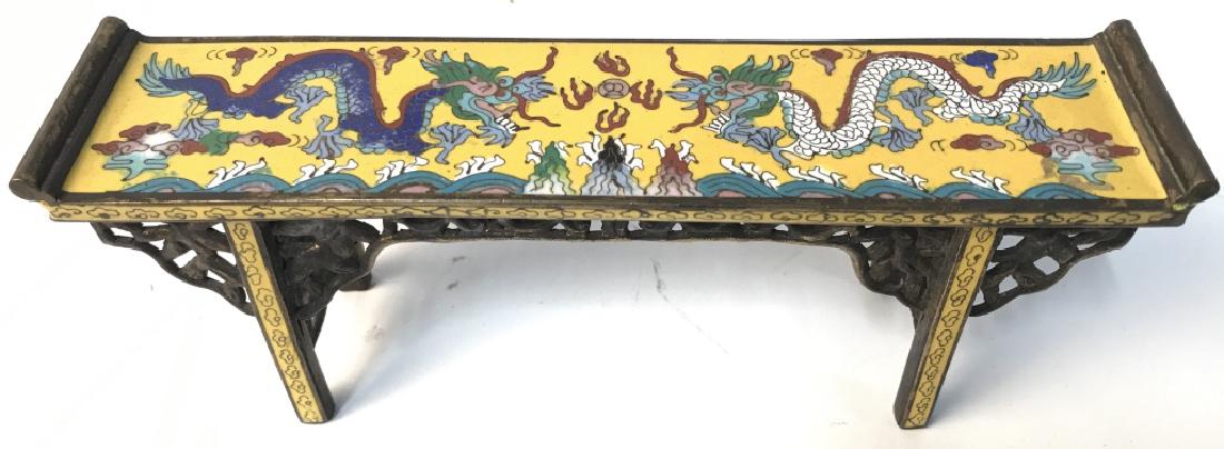 Miniature Enameled Asian Style Console Table: Piece is enameled/ Cloisonné with Asian Style. Contains intricate multi toned dragon detail. Measures approx 8 inches long 3 inches tall. 1.75 inches deep. Asian arts and crafts, decorative accessori