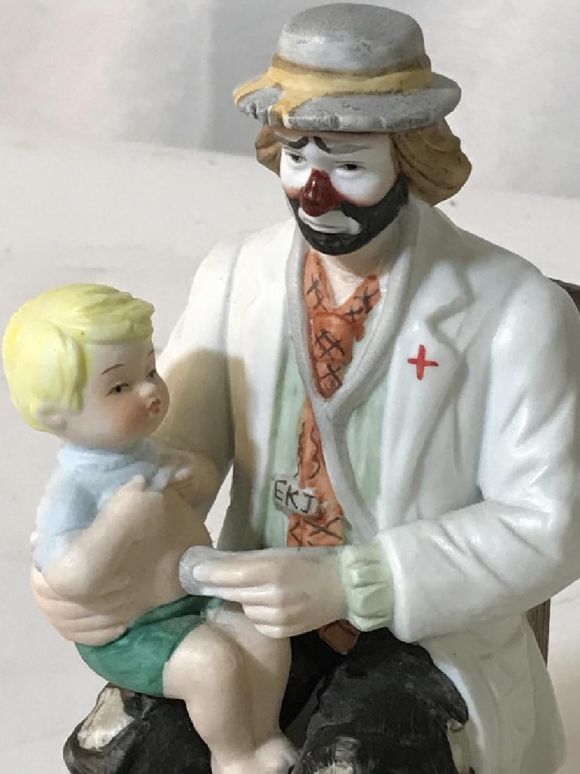 Vintage Handcrafted Porcelain Performance Clown: Comes with Description Tag. From Emmett Kelly Jr. Collection, 1984. Also stamp marked on underside. Known for its investment value. Comedy Performance Doctor Clown with toddler on knee. Base, 4.5 x 4