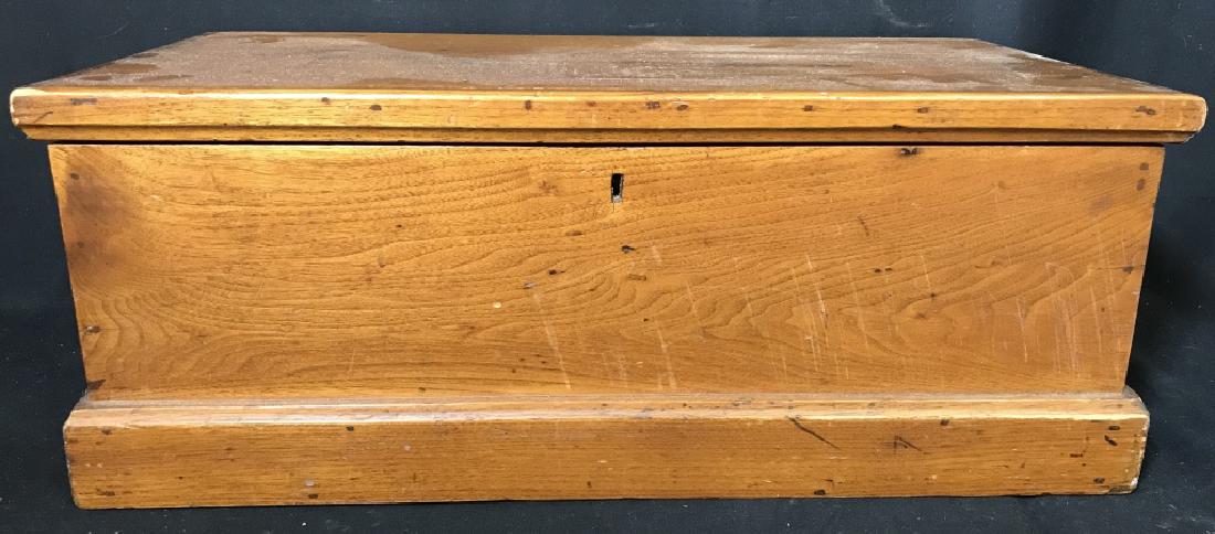 Americana Lidded Pine Box: Piece appears to be Pine. Piece is dark beige toned. Piece contains lid. Measures approx 26 inches long 12 inches deep 10 inches tall. Piece has keyhole right side of piece has Lidded compartment. Woo