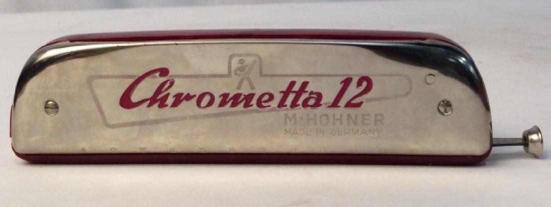 M. HOHNER Vintage Harmonica: Beautiful vintage M. Hohner Inc. of New York classic maroon harmonica inside a stamped red case. Made in Germany. Harmonica measures at approximately 1.7 inches tall and approximately 6 inches long. C