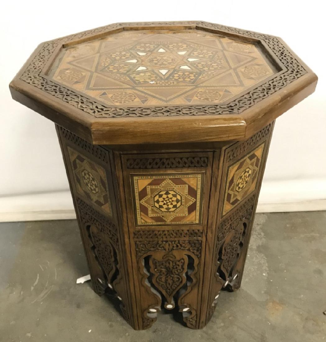 Wooden Inlaid Side Table W Mother Of Pearl Detail: Table has intricately carved wooden detail. Also contains intricate inlaid detail with various patterns and shapes. Table top has Octagonal shape. Measures approx 19 inches tall 16 inches wide. home f