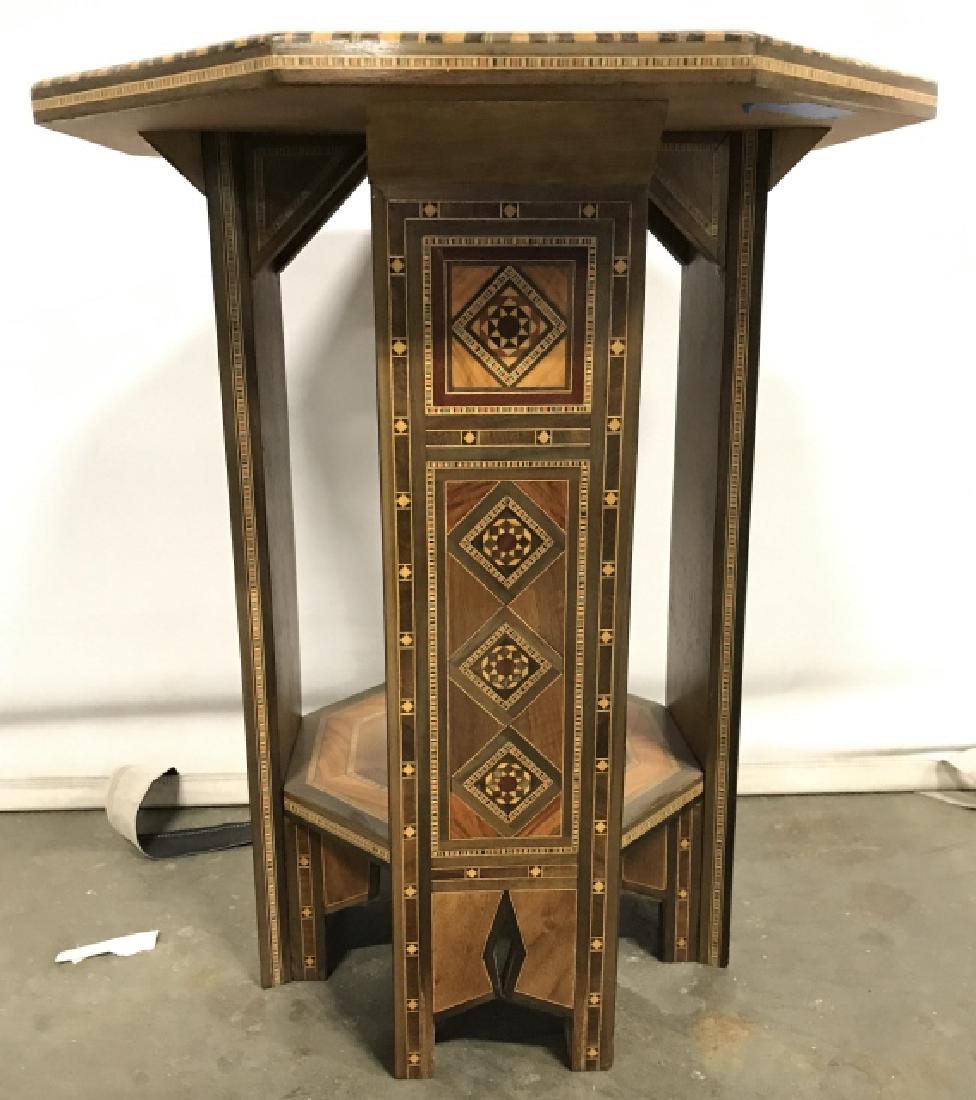 Wooden Inlaid Side Table W Mother Of Pearl Detail: Table has intricately carved wooden detail. Also contains intricate inlaid detail with various patterns and shapes. Table top has Octagonal shape. Measures approx 19 inches tall 16 inches wide. home f