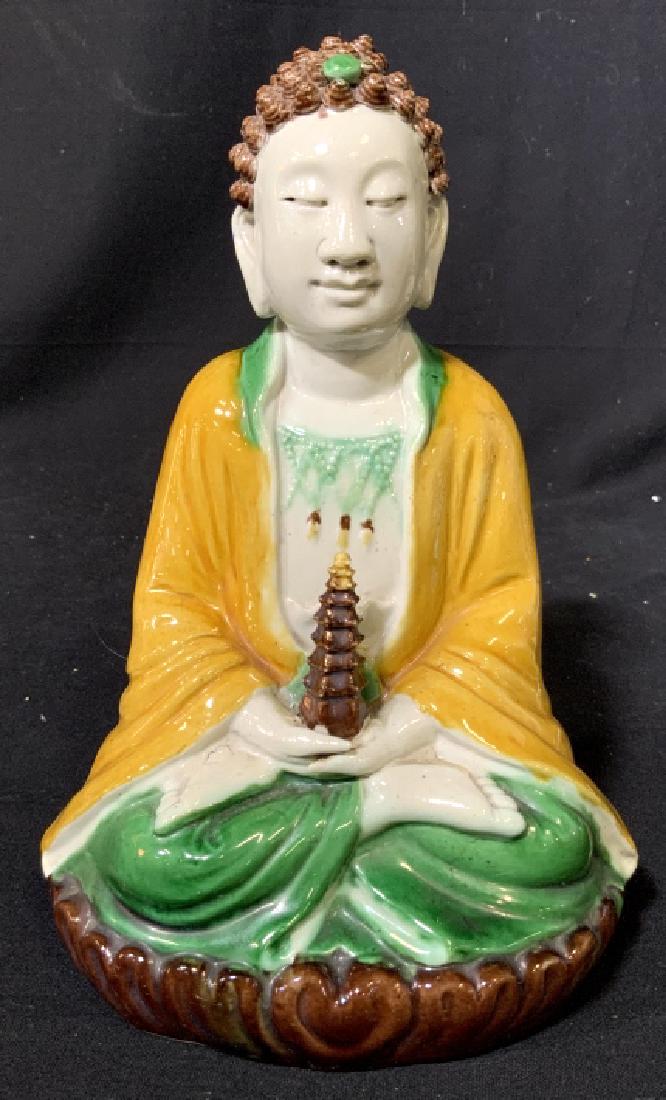 Signed Asian Porcelain Seated Buddha Figural: Asian ceramics, Asian pottery, orientalist, seated Buddha Figural in green and gold toned glazing, serene features, measures app ht 9.5 inches width 7 inches, signed illegibly underside asian arts and