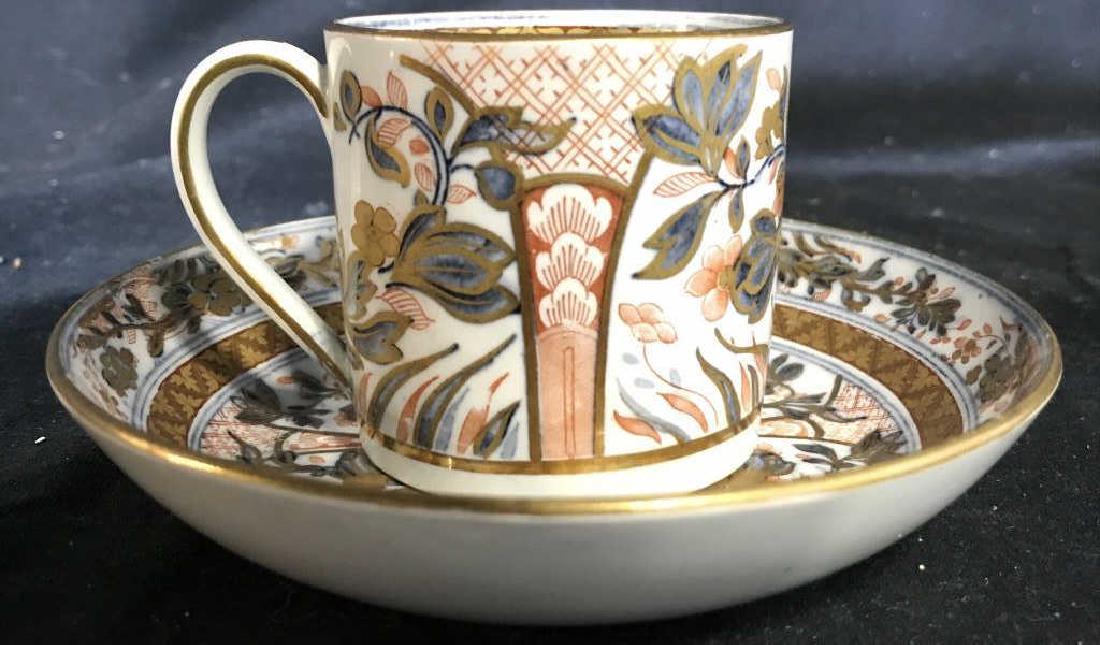 Lot 2 WEDGWOOD Teacup & Saucer: Lot includes 1 teacup & 1 saucer. Underside of saucer reads WEDGWOOD. Pieces have tones of gold, grey, & orange. Saucer measures approx 5.5 inches wide. Tea cup and saucer, tableware, individual tea s