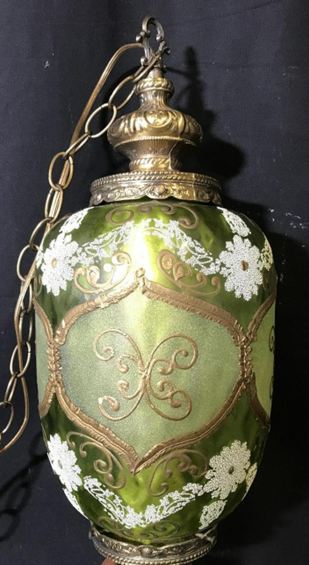 Bohemian Hanging Art Glass Lamp: Piece has tones of green, gold & white. Piece has Ornately Painted Gold Toned Detail. Top & bottom of piece appear to possibly be brass. Contains white toned floral detail. Measures approximately 24 i