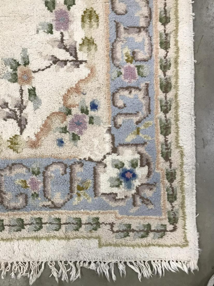 Handmade Floral Detailed Wool Rug: Rug is handmade with multi toned floral detail including tones of light blue, green, cream, and beige. Rug has fringes. Measures approx 112 inches long 64 inches wide. Home accessory and decor, decora