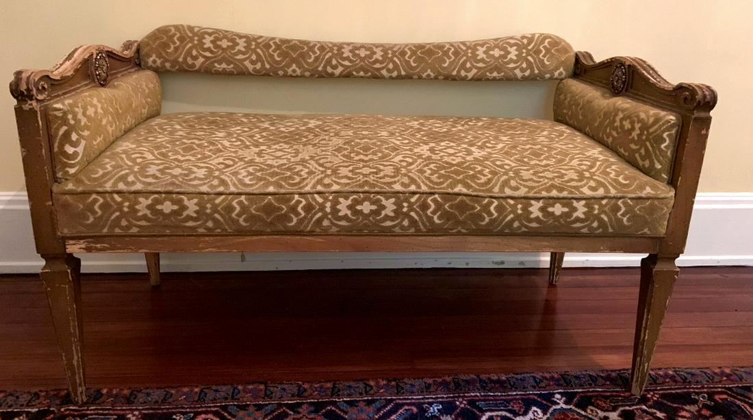 Vintage Cushioned Settee Bench: Piece is vintage. Contains gold toned cushioned area. Sides of piece have carved wooden detail with gold toned medallion detail. Measures approx 42 inches long, 24 inches tall, 22 incnes deep. Contain