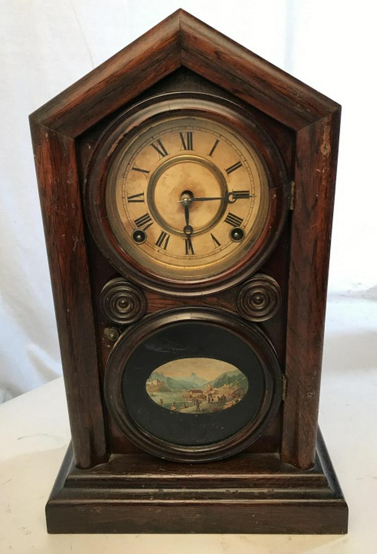 VINTAGE INGRAHAM & CO Wooden Mantel Clock: Interior is marked INGRAHAM & CO. Piece is vintage possibly antique. Contains cream toned clockface with black toned Roman numerals. Contains Clock door window which has oval shaped outdoor scene. Pie