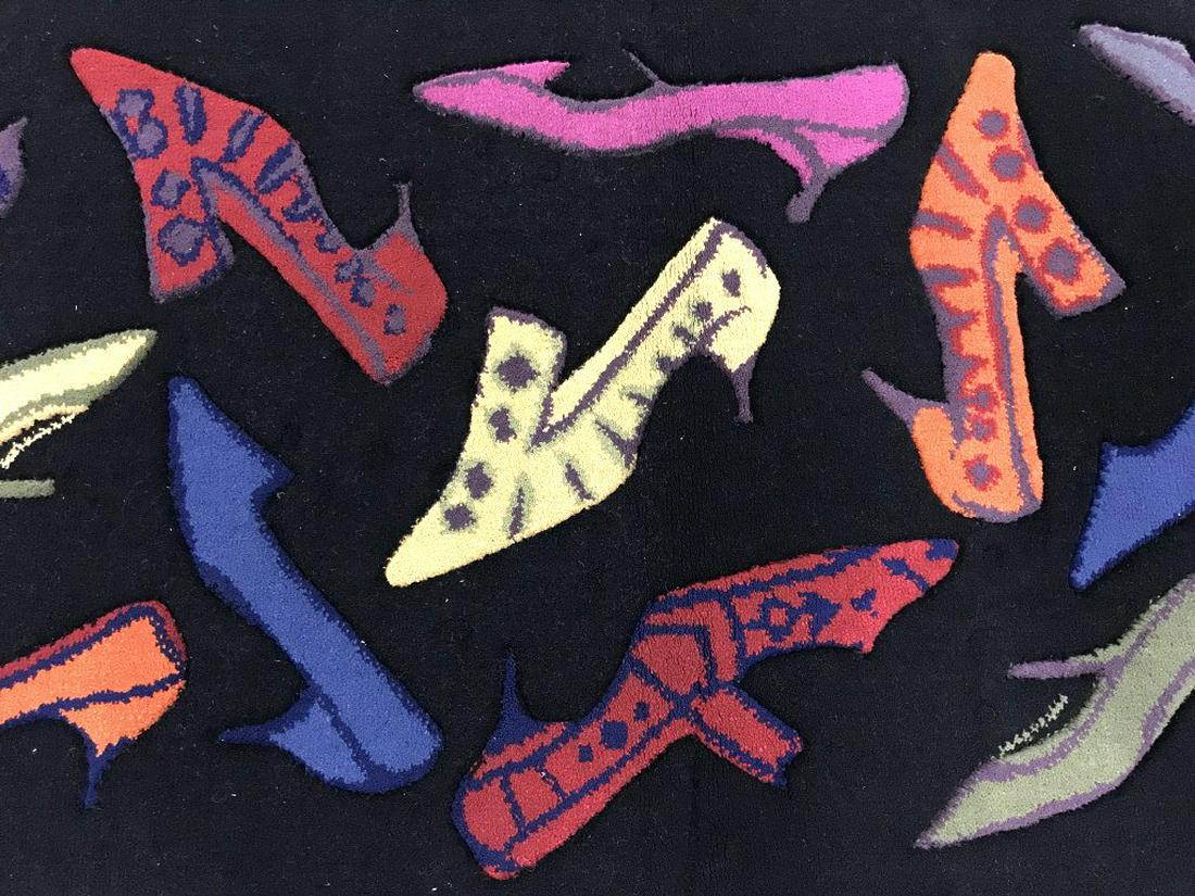 ANDY WARHOL Shoes Galore Rug by Oriental Weavers: An Andy Warhol ‘Shoes Galore’ rug from the Andy Warhol Home Collection by Oriental Weavers. Rug features a whimsical pattern of high heel shoes in different colors against a black tone background.