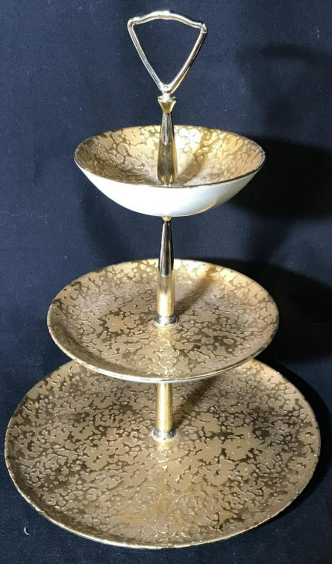 Three Tier 32 K Gold Hand Decorated Dessert Tray: Marked on underside. 32 K Gold USA Weeping Bright Gold. Bottom plate measures a little over 10 in. Height approx 14 in. Top plate is more like a shallow bowl. All gold surface, underside cream porcela