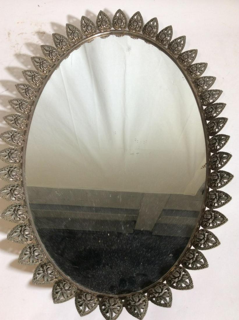 Vintage Vanity Mirror Tray: Mid Century Oval Shaped Mirror Tray with Filigree Rose Metal Design, possibly brass. 23 in long, 15 in wide. Felt covers underside. Small scratch on side of mirror. Sectionof metal are warped, Metal T