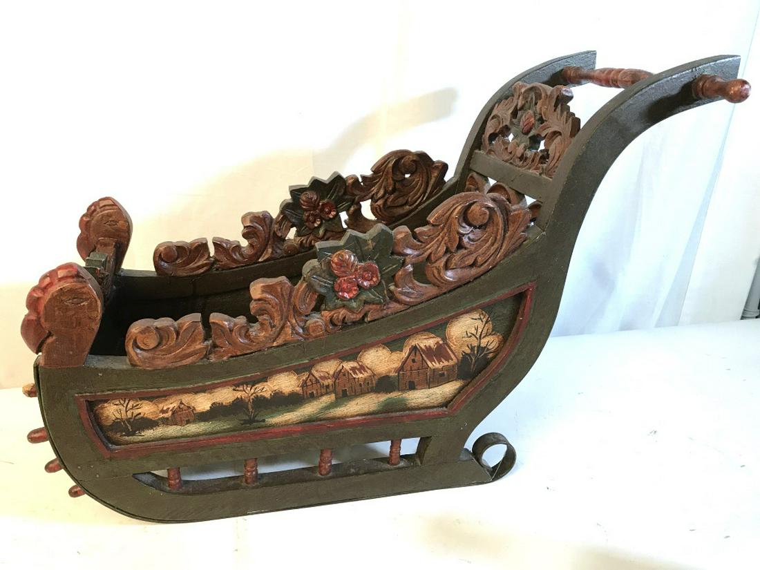 Antique Hand-Painted Folk Art Sleigh for Doll: Possibly 19th Century Hand-Carved Wood And Painted folk Art miniature sleigh for doll or small child. Sleigh features red and green color palette with winter scenes along exterior. Measures approx 17 