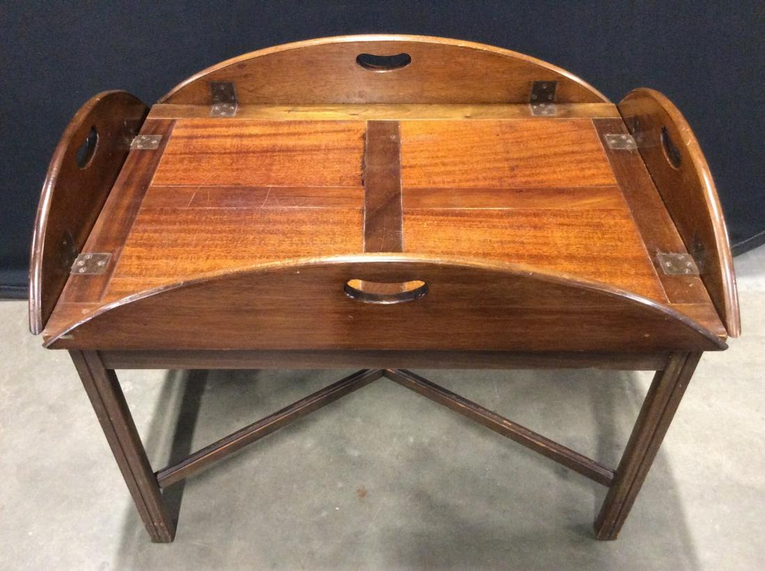 Vintage Wooden Butler’s Tray Table: Butler's tray table with countersunk hinges that allow the sides to fold upwards and the tray to be carried. Measures approx 23.25 inches in height by 30.5 inches by 21 inches in length and width when