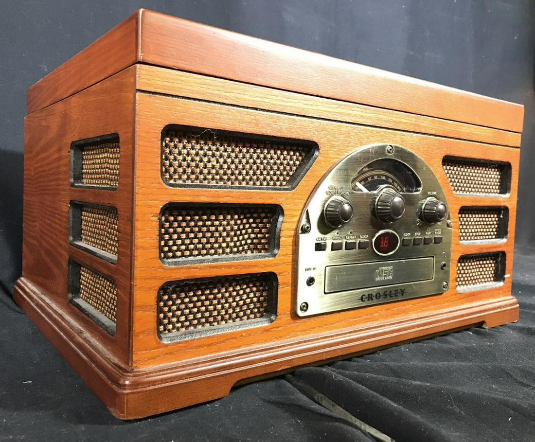 CROSLEY Radio & Record Player: Front of piece reads CROSLEY. Piece has 3 knobs, 7 buttons, compact disc slot, line in & headphone jack. Measures approx 18 inches long 9 inches tall, 14 inches deep. radio, electronics, record player