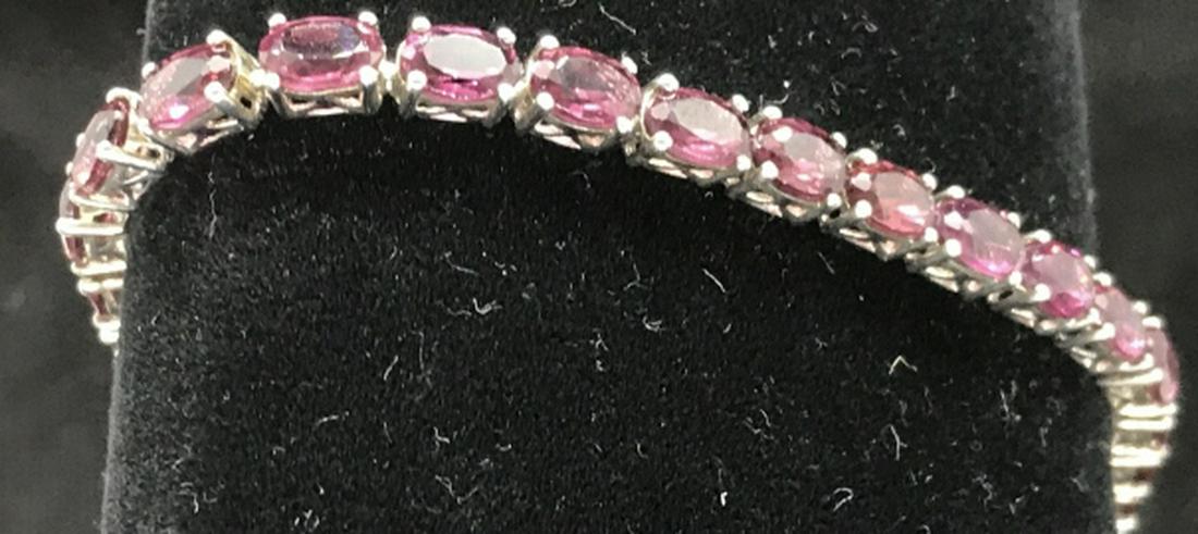 Raspberry Garnet 7 3/4in Sterling Silver Bracelet: Authentic Garnet. 31 Stones. 7 3/4 in. Long. Secure clasp with push to open button. Sterling Silver setting, 4 prong. Garnet is January Birthstone. Comes in a box. Garnet, January Birthstone, Semi Pre