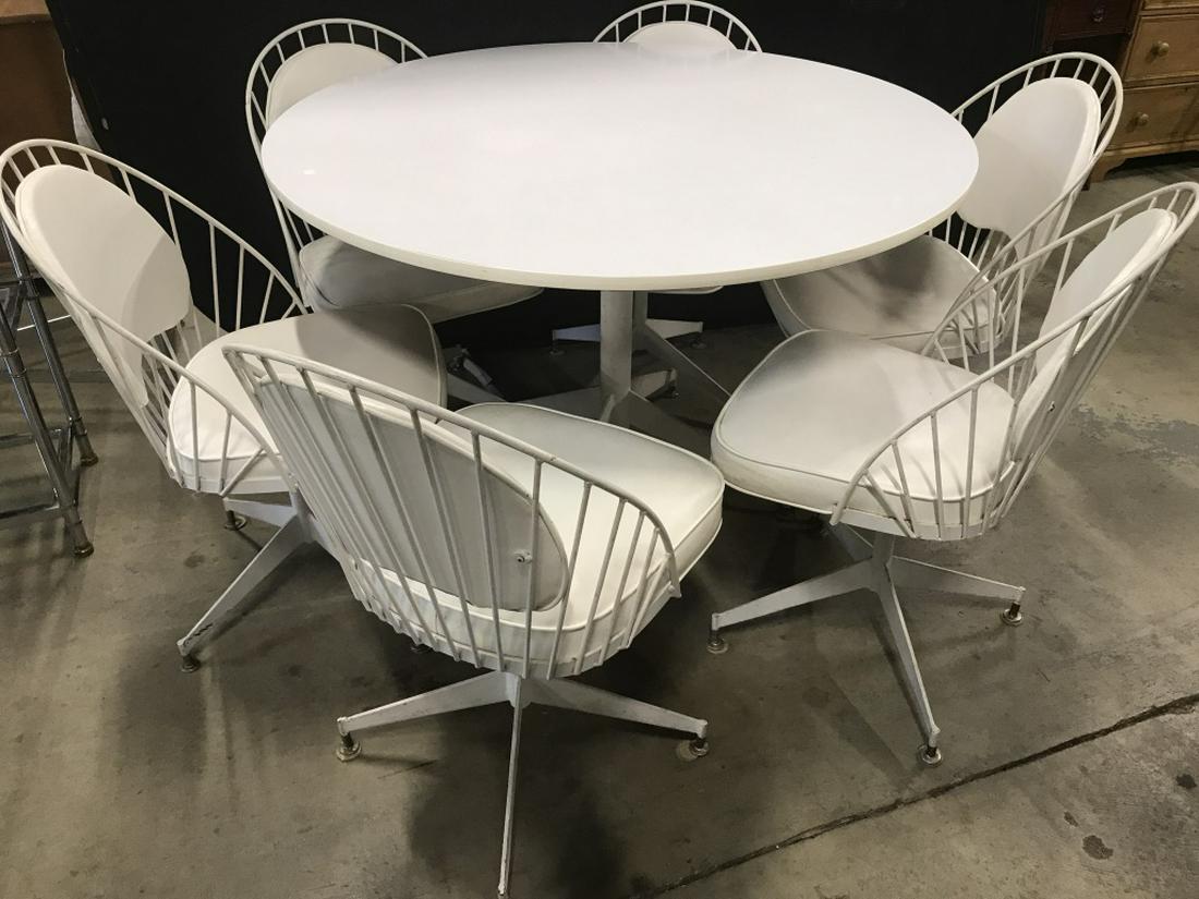 Set 7 Mid Century Modern Table & Chairs: Lot includes 1 round white toned table & 6 white toned Pedestaled Side Chairs. Each chair has white toned cushioned Seats & white toned cushioned backrests. Table measures approx 48 inches wide 30 inc