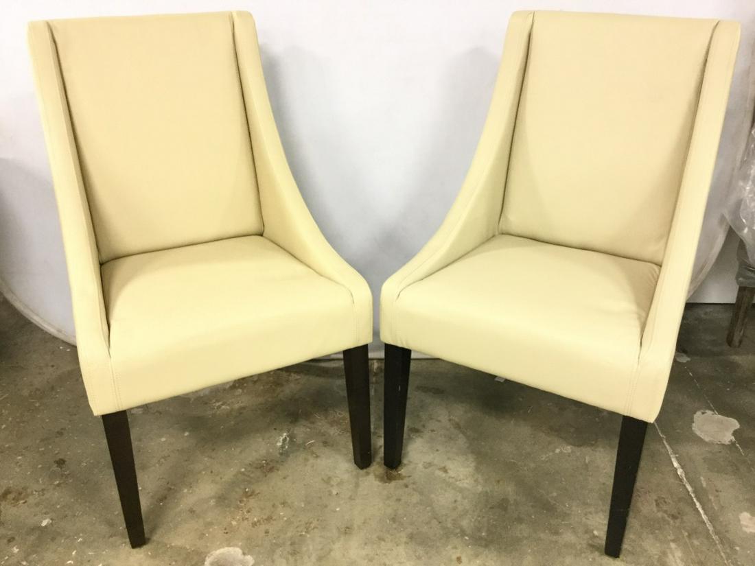 SAFAVIEH Sand Toned Studded Side Chairs: Lot includes 2 Side Chairs each are sand toned. Contains 4 wooden legs. Chairs have some surface wear. Chairs are in the style of real leather. May need minor restoration. Each measures approx 37 inch