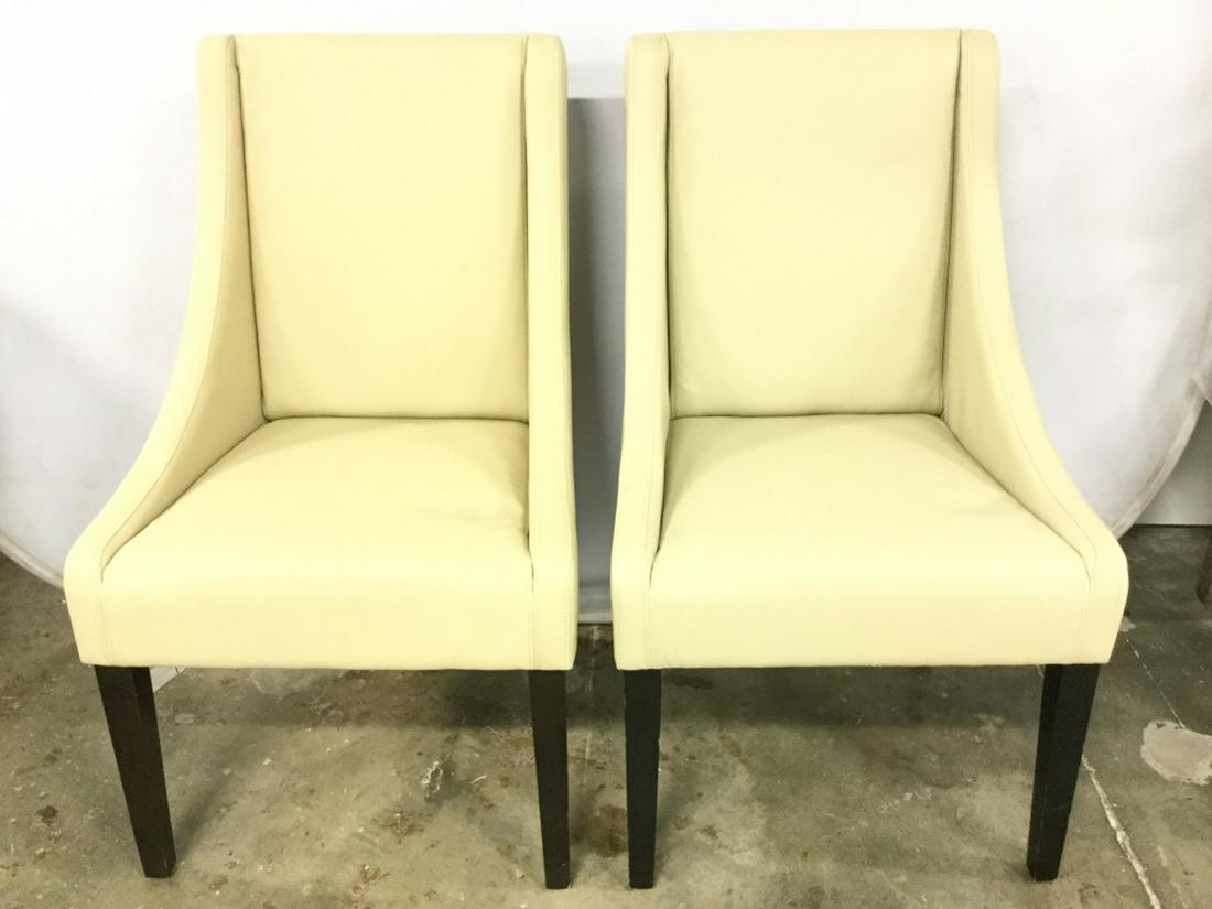 SAFAVIEH Pair Sand Toned Studded Side Chairs: Lot includes 2 Side Chairs each are sand toned. Contains 4 wooden legs. Chairs have some surface wear. Chairs are in the style of real leather. May need minor restoration. Each measures approx 37 inch