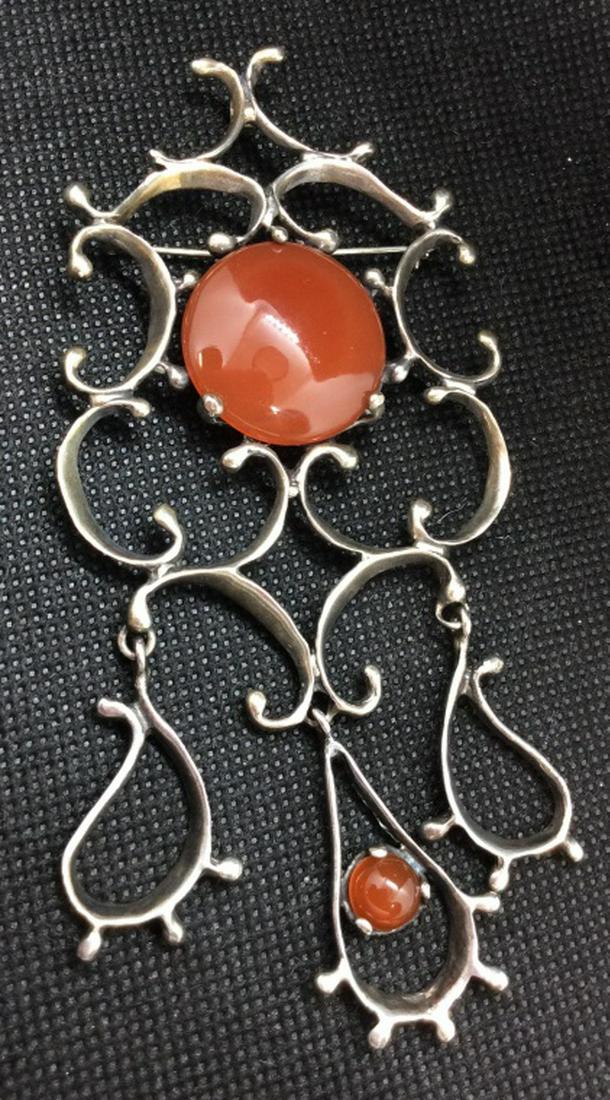Sterling Carnelian Brooch Pin Pendant: Sterling silver, carnelian Natural Stone cabochons, twisting line design, loop for pendant. Statement jewelry. Measures approx 3 by 4 1/2. Women’s Statement Jewelry, fashion accessory, Estate Jewelr