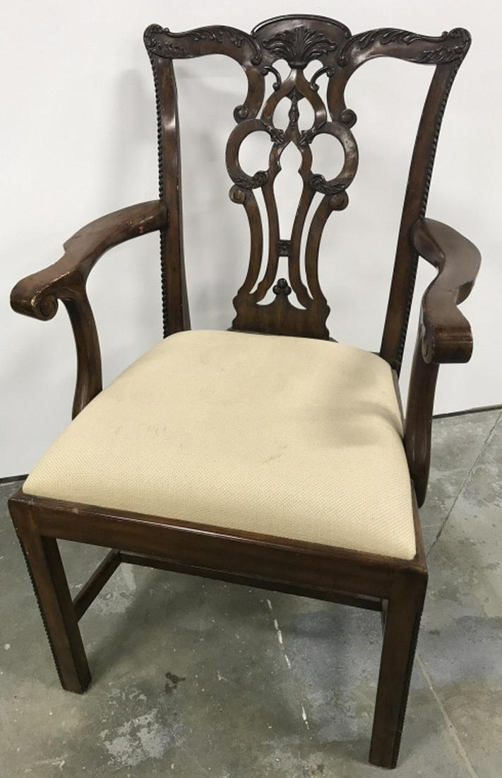 MAITLAND-SMITH Carved Wooden Armchair: Underside marked for MAITLAND-Smith. Carved wooden armchair with Upholstered Seat. Dark tone wood with beige tone fabric upholstery on Seat. Measures approx 37.5 inches in height by 24 inches in width