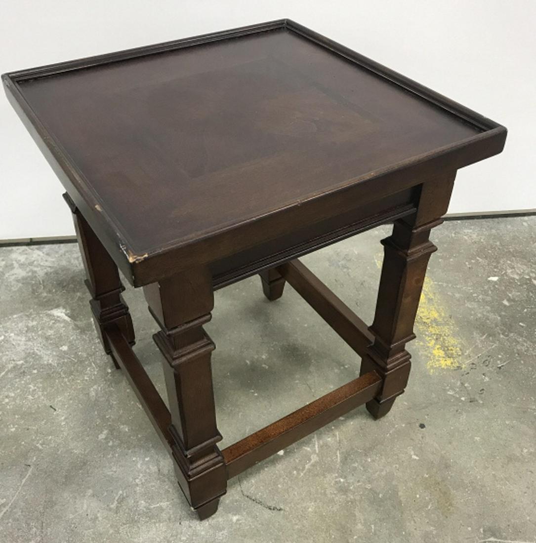Petite Wooden Side Table: Dark tone wood side table. Measures approx 17 inches in height by 14 inches squared in length and width. Some minor surface wear like light scratches. One bottom panel bracket needs replacing. Interio