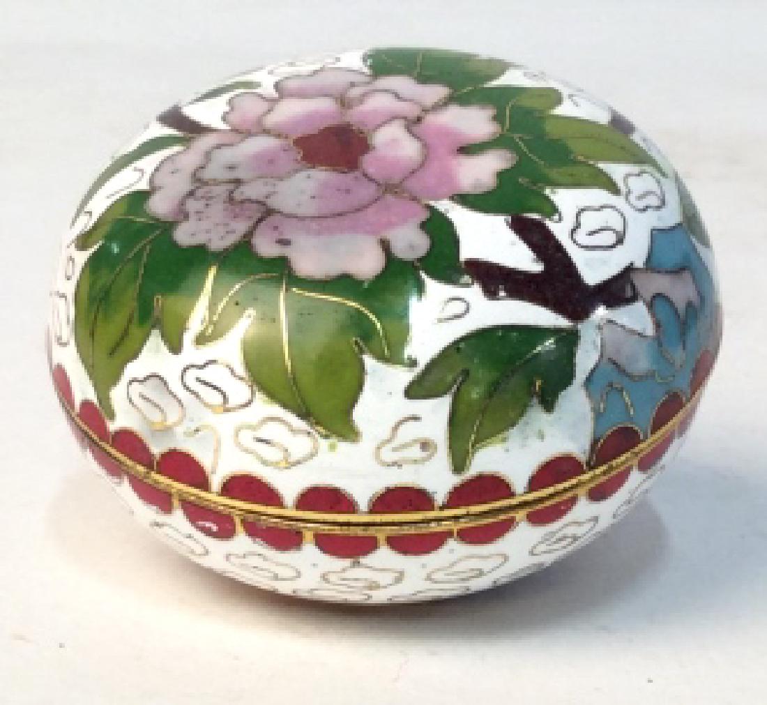 Round Cloisonné Trinket Box: Tiny possibly vintage cloisonné white, pink, and green multi purpose Trinket Jar. Blue painted interior with gold metal trim. Trinket jar measures at approx 1.8 inches tall, and approx 2.3 inches in 