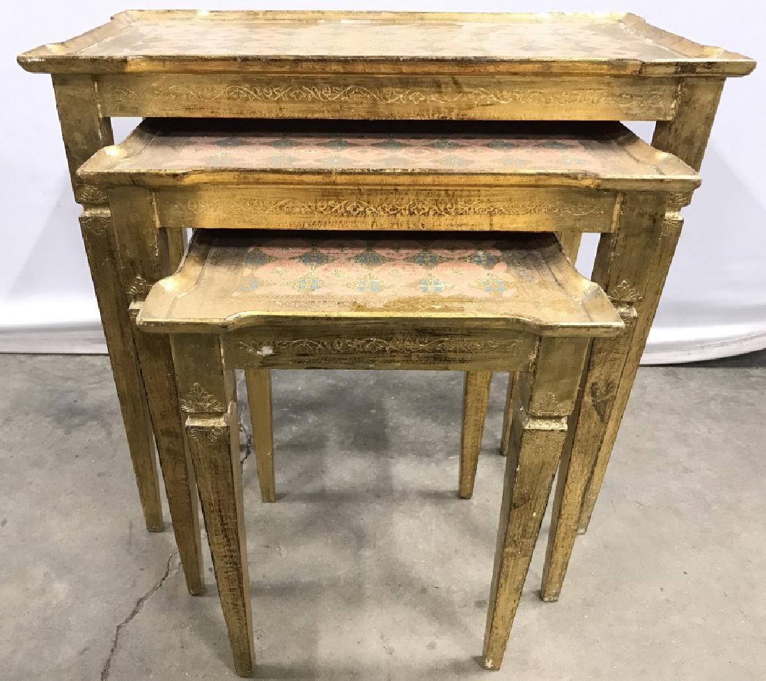 Lot 3 Gold Leafed Nesting Tables: Lot includes 3 nesting tables. Each appear to be gold leafed. Each contains coral, teal & gold toned patterned Detail. Largest nesting table measures approximately 22 inches tall 24 inches long 13 inc
