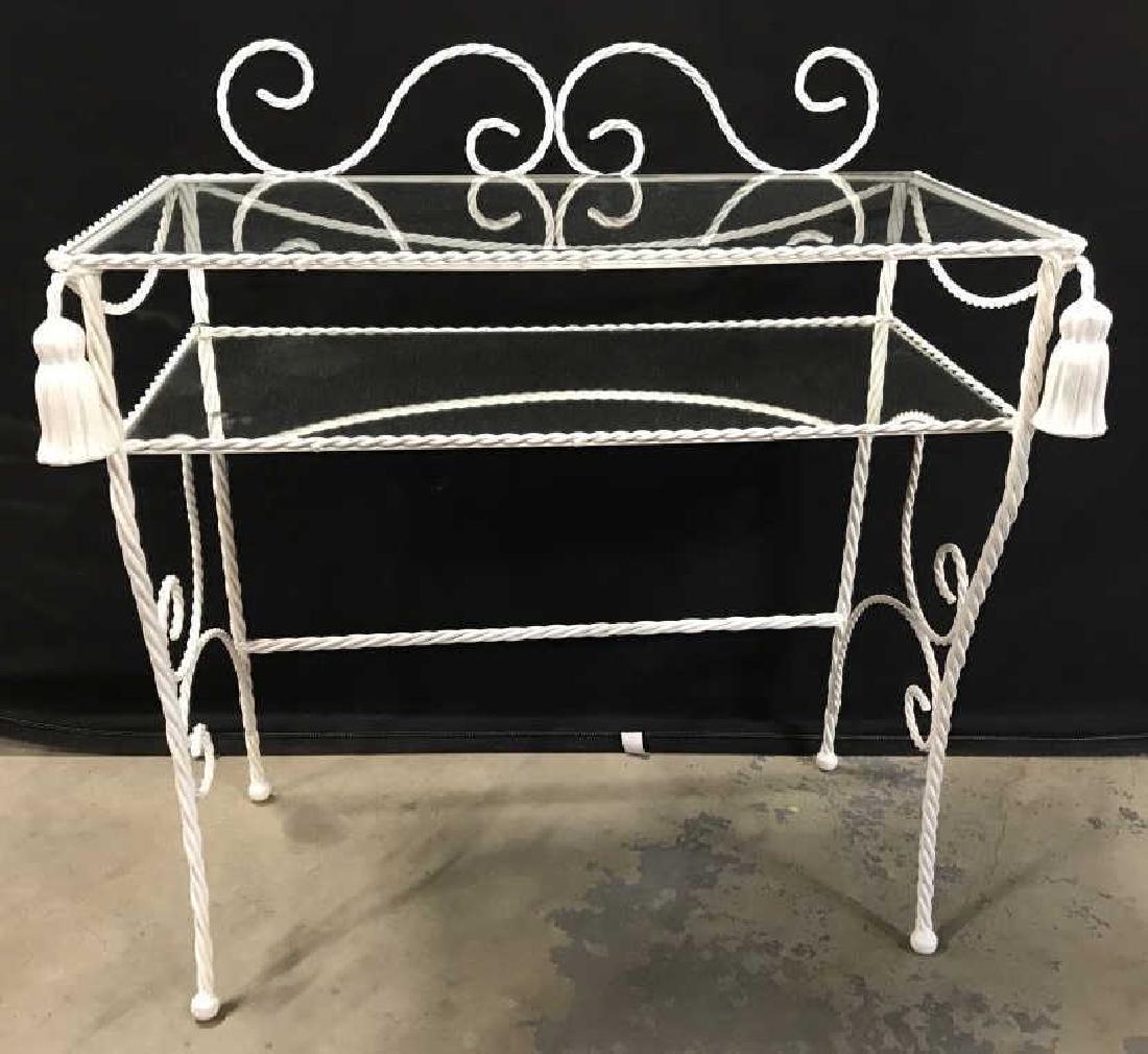 Vintage Metal Side Table W Glass & Mirror Shelves: Vintage white tone painted metal side table with glass top shelf and mirror bottom shelf directly below. Scroll & tassel detailing. Measures approx 33 inches in height by 29.5 inches in width by 15.5 