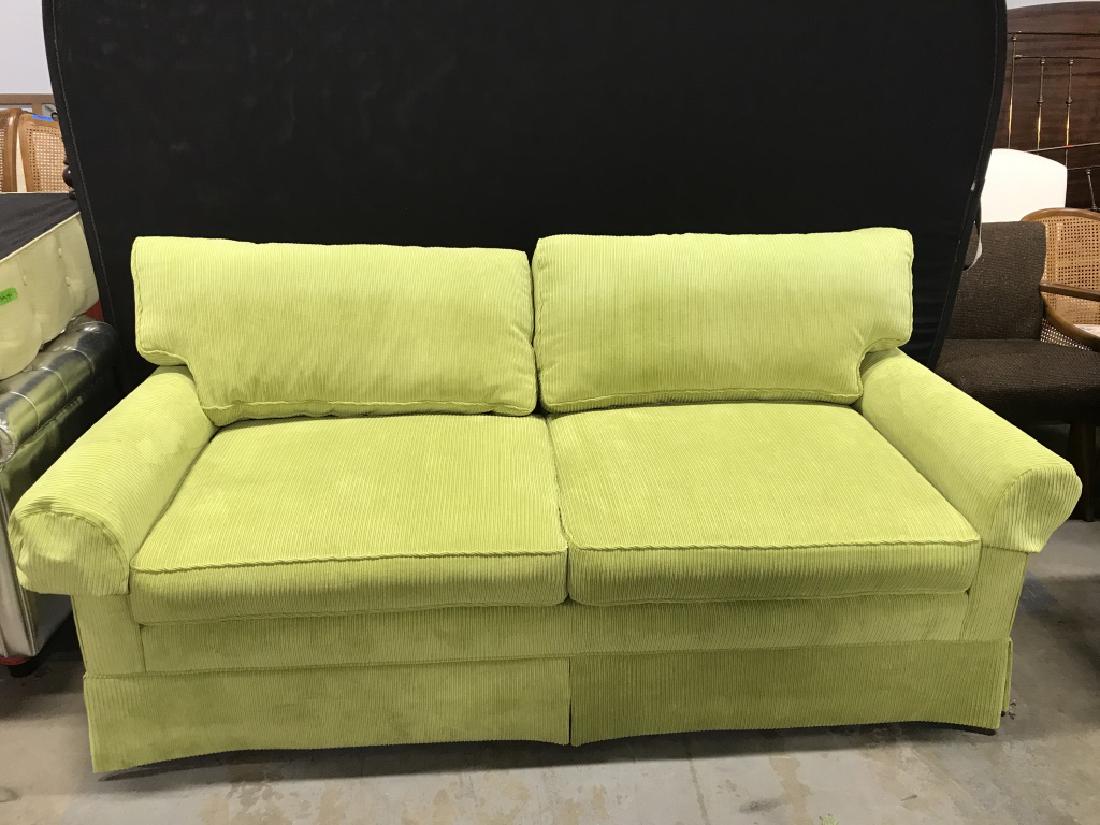 Vibrant Chartreuse Green Skirted Corduroy Couch: Couch is fully upholstered in vibrant lime green / chartreuse green tone ribbed, corduroy style fabric. Skirted bottom. Measures approx 34 inches in height by 76 inches in width by 36 inches in depth.