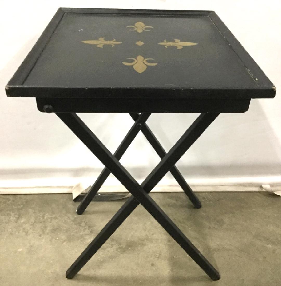 Pair FLEUR DE LIS Detailed Television Tables: Lot includes 2 television dinner tables. Each are black toned with Gold Toned FLEUR de lis Detail. Each piece measures approx 26 inches tall 20 inches wide 16 inches deep. tv trays dinner trays, home