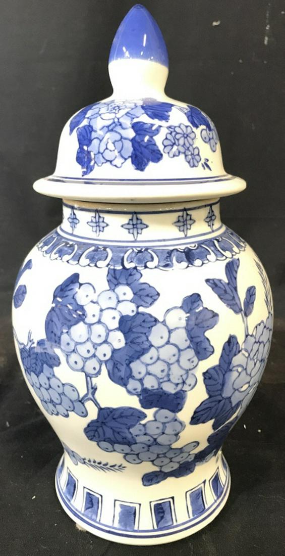 Floral Detailed Asian Style Ginger Jar / Urn: Piece is blue and white toned. Contains blue toned floral, vine leaf and grape detail. Urn includes lid. Measures approx 11 inches tall 6 inches wide. Tableware, decorative arts and accessories, home 