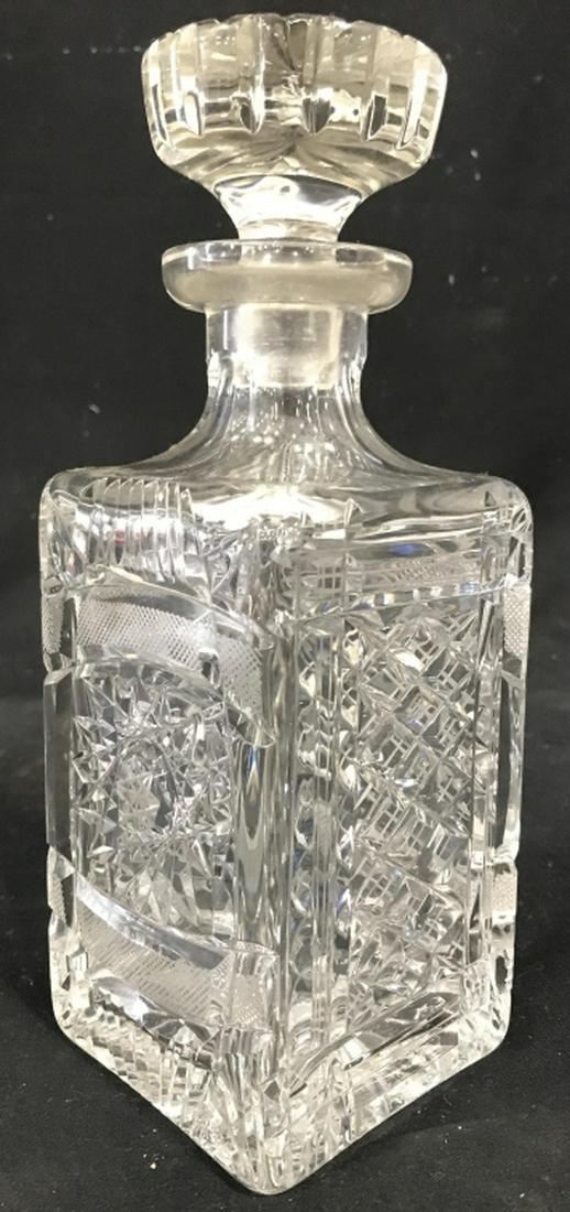 Cut Crystal Decanter W Stopper: Decanter is Cut Crystal. Contains intricately cut geometric detail. Decanter includes stopper. Measures approx 10 inches tall 3.5 inches wide and deep. decanter, barware, shelf piece, decor piece, 6.