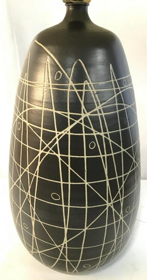 Chocolate Toned Ceramic Lamp W Shade: Lamp is chocolate toned with irregular line detail. Piece includes shade and finial. Piece measures approximately 32 inches tall 10 inches wide. Vintage lamps, table lamps. home accent and decor, home
