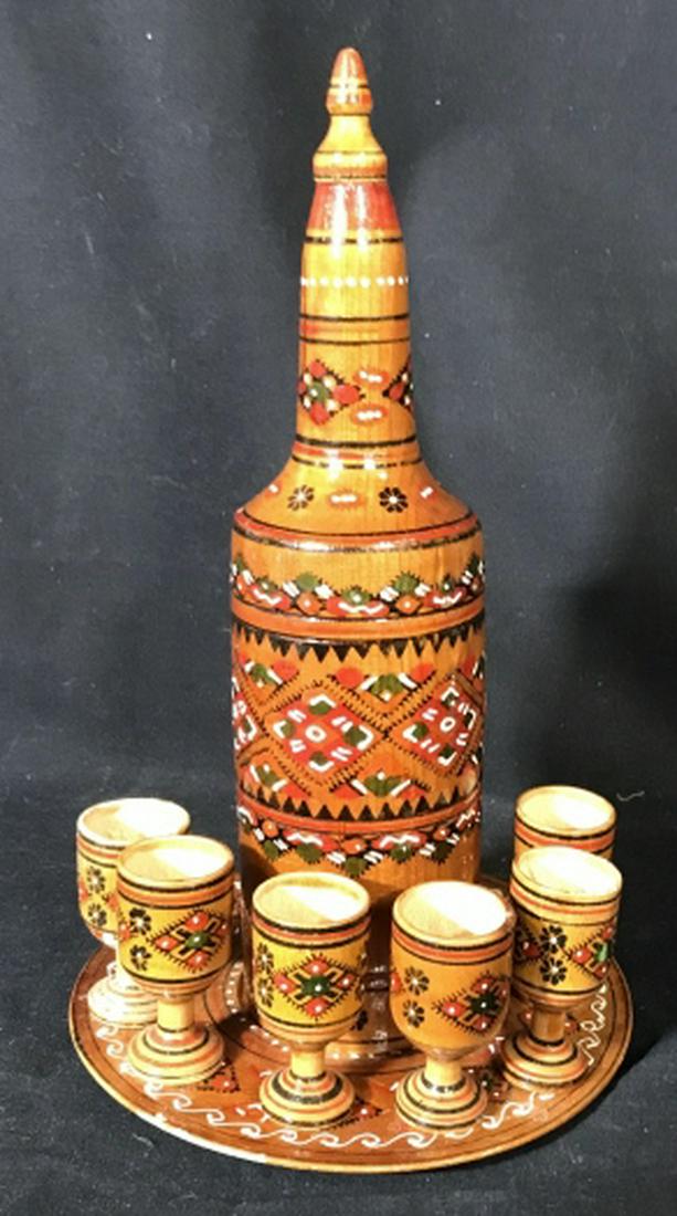 Vintage Ukrainian Karafka with Drinking Cups: Handcrafted & Hand Painted Vintage Russian/ Ukrainian Decanter, Dish, And 6 Cups. Use as decor. Some wear on wood but in good condition. Decanter has top that comes off. Measures 10 3/4 in. tall. Plat