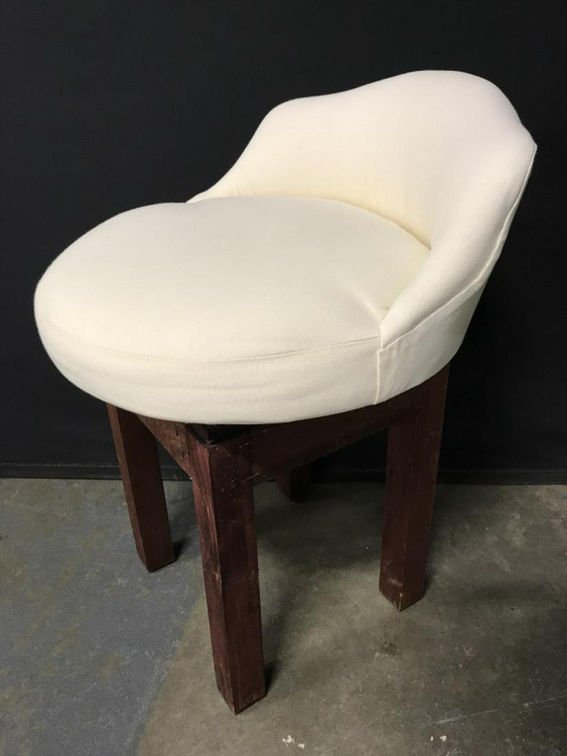 Cushioned Swivel Stool W Low Back: Cushioned swivel stool sits atop wood base. Measures approx 26 inches in height by 19 inches in diameter. Some surface wear of wood base, might need minor restoration. Swivel stool, bathroom stool, sw