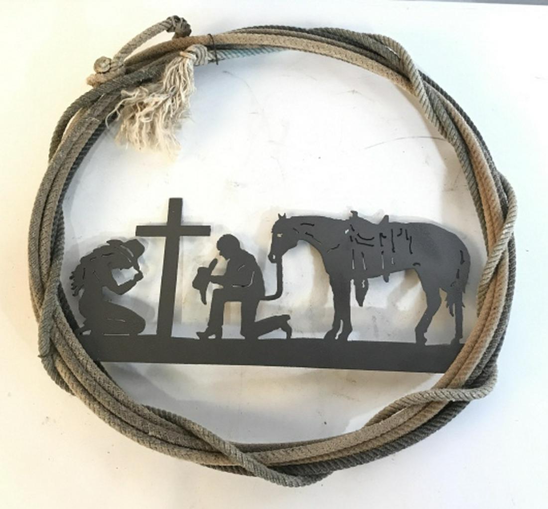 Metal and Rope Horse Cowboy Wall Sculptural: Entwined rope frames cut out metal scene of kneeling cow boy and cowgirl at cross, with saddled up horse, western wall art, religious wall art,bar art western style arts and crafts,diameter app 19 inc