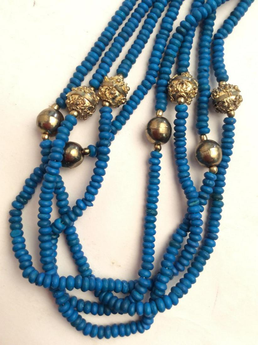Dark blue toned beaded necklace: Multi stranded women’s Necklace Dark blue toned beads with brass toned spacer beads. Blue beads possibly coral, or Shell, Measures approx 13 in long, Jewelry, women’s vintage costume estate jewelr