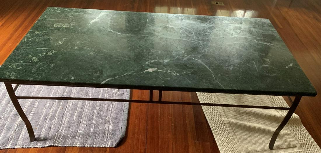 Wrought Iron Marble Top Coffee Table: Coffee Table appears to possibly have Wrought Iron base. Tabletop is green toned, possibly marble, possibly stone. Piece measures approx 48 inches long 24 inches deep 16 inches tall. coffee table, hom