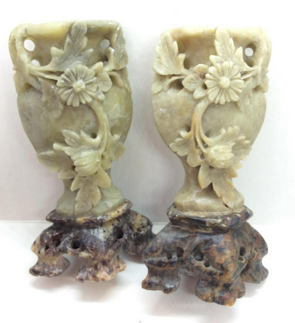 Natural stone Carved Asian Miniature Urns: Miniature urn Vases, possibly carved soapstone or other natural stone, pale green toned asian Urns with wrapping floral design and brown toned bases. Measures approx 4 in by 2 1/2 in by 1 1/2 in. Asia