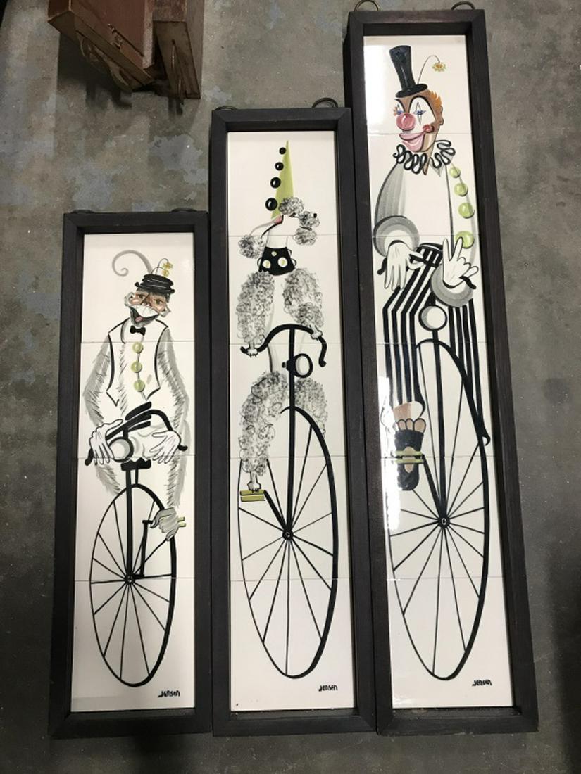 Lot 3 Jensen Signed MCM Tile Artworks, Circus: Lot 3 Jensen signed mid-Century modern tile artwork depicting a clown, a monkey, and a poodle dog on unicycles. Tiles are set in black tone wood frames. Tallest artwork measures approx 37.5 inches in 