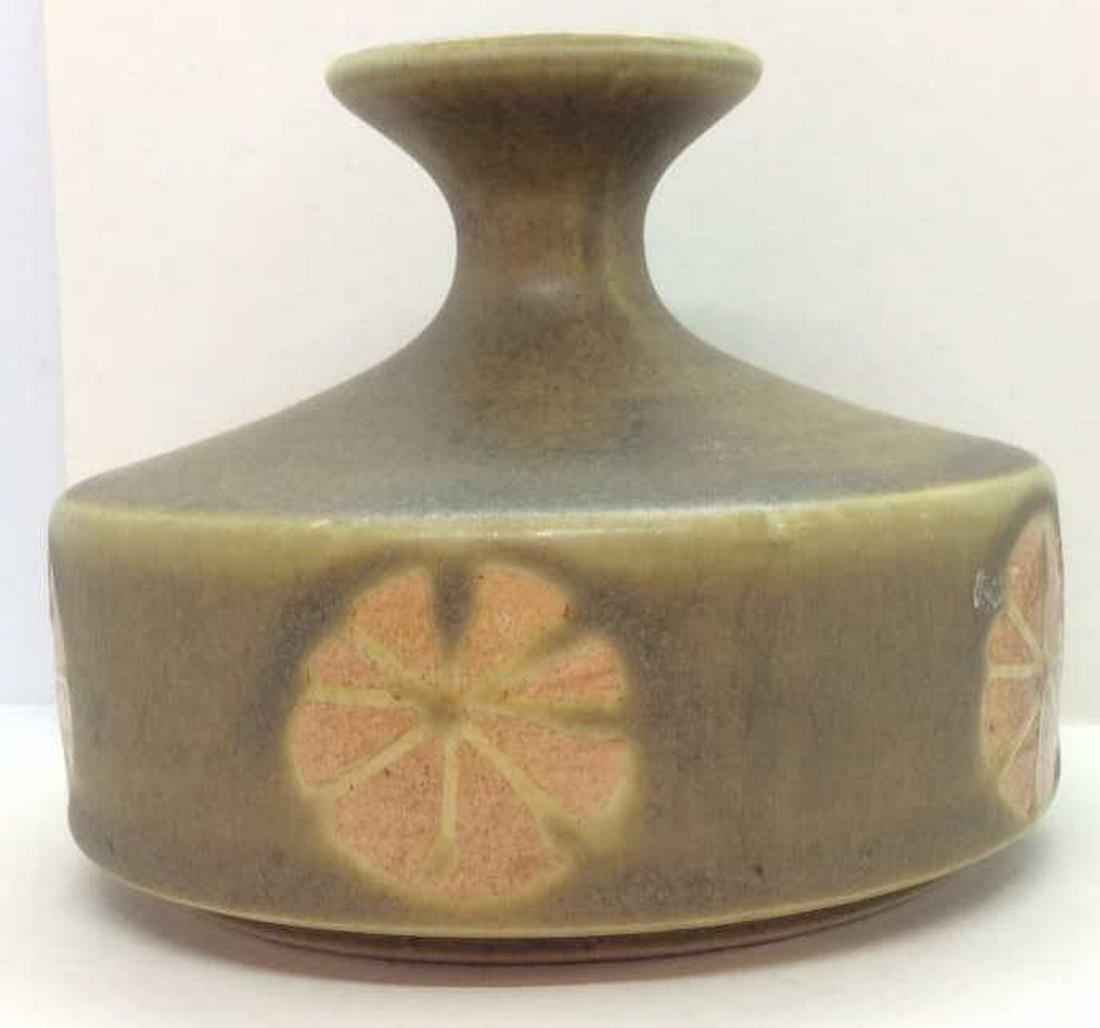 Stoneware Ceramic Bud Vase: Moss green toned glaze, exposed glaze floral motif design, measures approx 4 in tall by 4 1/2 in in diameter, bud vase, decorative accessory, shelf piece, decorative tabletop accessories. 4
