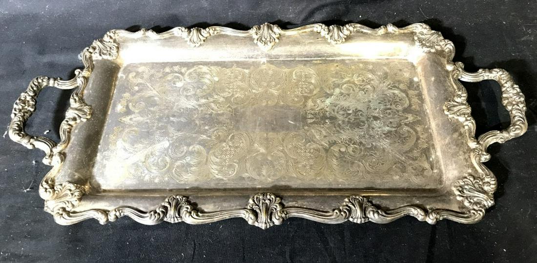 FB ROGERS Silver Toned Metal Serving Tray: Serving tray is metal and silver toned. Underside of piece reads FB ROGERS. Piece measures approx 22 inches long 11 inches wide. Contains some wear. centerpiece, serving tray dinnerware, serving platt