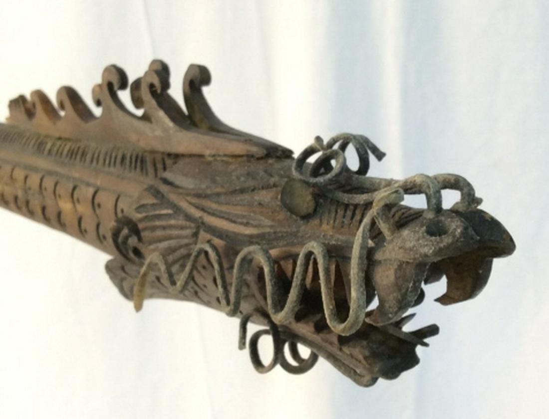 Indonesian Blow Dart Gun: Intricately carved Wooden Indonesian dragon blow dart gun. Comes with hanging wooden dart keeper with original darts included. Dart gun measures at approximately 32 inches long, and approximately 3 in