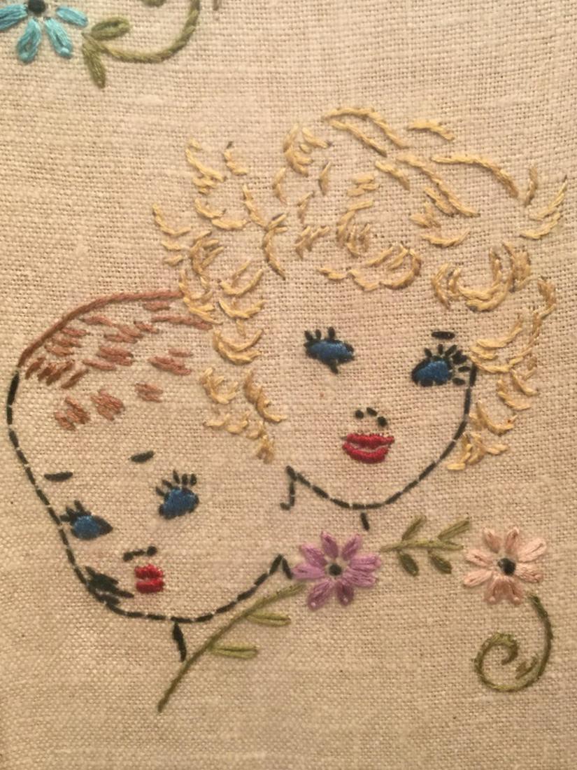 Vintage Motto Sampler, August’s Child: Sampler features the saying ‘August’s child must busy be if they live quite happily.’ Embroidered Portraits Of children with floral motifs. Sampler is set behind glass in wood frame. Frame measu