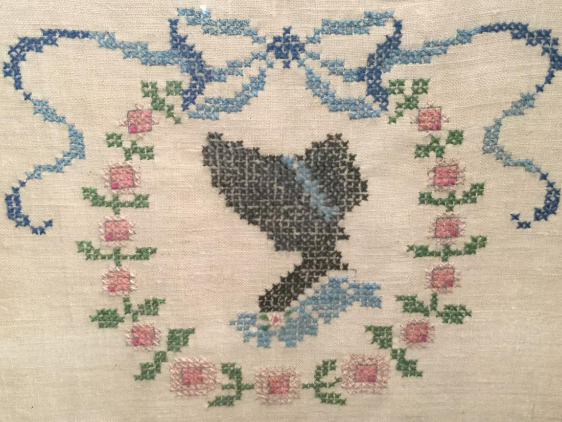 Vintage Motto Sampler, Loom Of Life: Sampler features the saying ‘in the loom of life let us weave our golden dreams.’ Embroidered silhouette portrait inside floral wreath along top. Sampler is set behind glass in wood frame. Frame m