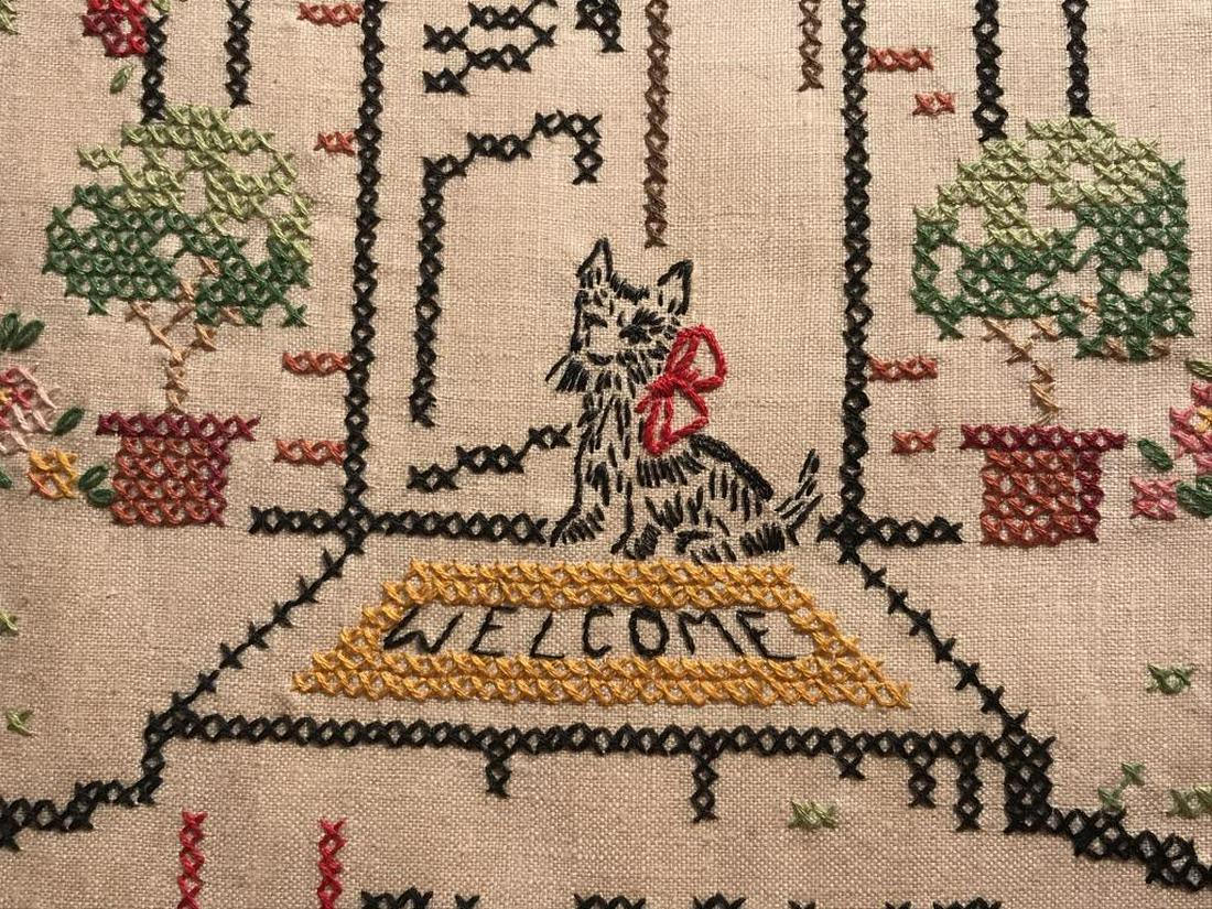 Vintage Motto Sampler, Shakespeare Quote: Sampler features the Shakespeare quote ‘Welcome ever smiles and farewell goes out sighing.’ Embroidered dog in entryway with flowers motif. Sampler is set in gold tone wood frame. Frame measures a